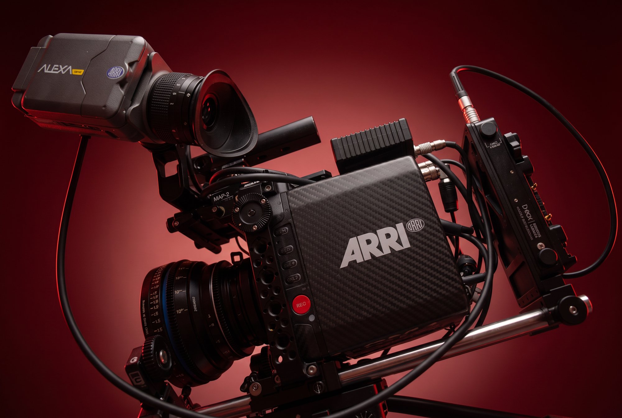 Professional cinema camera under dramatic red lighting